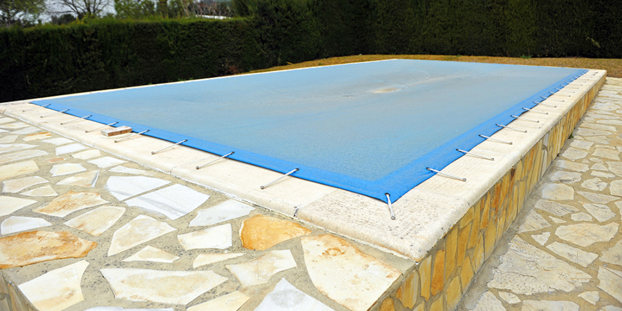 pool covered with blue tarp